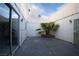Private outdoor patio with a palm tree and surrounded by white fencing at 3467 Garden East Dr, Las Vegas, NV 89121