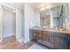 Bathroom featuring double vanity, granite countertop, and walk-in shower with contemporary fixtures at 353 E Bonneville Ave # 746, Las Vegas, NV 89101