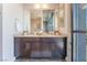 Bathroom featuring granite countertop, double vanity, and large mirror providing ample space for two at 353 E Bonneville Ave # 746, Las Vegas, NV 89101