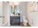 Well-lit bathroom with granite counters, decorative mirror, and neutral paint at 353 E Bonneville Ave # 746, Las Vegas, NV 89101