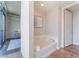 Bathroom showcasing a soaking tub, tile flooring, and contemporary design elements near bedroom at 353 E Bonneville Ave # 746, Las Vegas, NV 89101