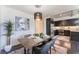 Cozy dining room with modern lighting, stylish table setting, and adjacent gourmet kitchen at 353 E Bonneville Ave # 746, Las Vegas, NV 89101