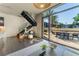 Open-concept living area with floor-to-ceiling windows, modern staircase, and outdoor patio access at 353 E Bonneville Ave # 746, Las Vegas, NV 89101