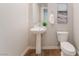 Cozy powder room with a pedestal sink, a modern toilet, and neutral walls at 353 E Bonneville Ave # 746, Las Vegas, NV 89101