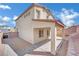Exterior view of the home showcasing the covered patio and landscaped backyard at 389 Scarlet Pine Ct, Henderson, NV 89044