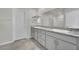 Bathroom featuring double sinks with granite countertops, a spacious vanity, and tile flooring at 389 Scarlet Pine Ct, Henderson, NV 89044