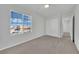 Bedroom showcasing neutral carpet, a window, and a closet with white doors at 389 Scarlet Pine Ct, Henderson, NV 89044