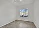 Simple bedroom with neutral walls, tile floors, and a bright window at 389 Scarlet Pine Ct, Henderson, NV 89044