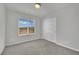 Bright bedroom featuring neutral carpet, closet, and a window with mountain views at 389 Scarlet Pine Ct, Henderson, NV 89044