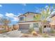 Beautiful home featuring a paved driveway, a two-car garage and lush landscaping at 389 Scarlet Pine Ct, Henderson, NV 89044