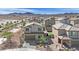View of the home exterior showing landscaping, turf backyard, and neighboring houses at 389 Scarlet Pine Ct, Henderson, NV 89044