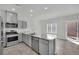 The kitchen features stainless steel appliances, a granite island, and recessed lighting at 389 Scarlet Pine Ct, Henderson, NV 89044