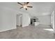 Open living space with tile flooring, neutral colors, and an open kitchen with granite countertops at 389 Scarlet Pine Ct, Henderson, NV 89044