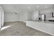 A modern living space features a view of the kitchen with granite countertops, tile floors, and stainless appliances at 389 Scarlet Pine Ct, Henderson, NV 89044