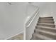 Carpeted staircase with a handrail, providing a safe and stylish transition between floors at 389 Scarlet Pine Ct, Henderson, NV 89044
