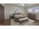 Staged bedroom with wood floors, neutral decor, ceiling fan and updated windows at 401 Altamira Rd, Las Vegas, NV 89145