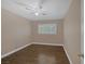 A simple bedroom with wood-look floors, neutral paint, and a ceiling fan at 401 Altamira Rd, Las Vegas, NV 89145