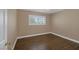 A simple bedroom with wood-look floors, neutral paint, and bright window at 401 Altamira Rd, Las Vegas, NV 89145