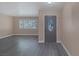 Entryway featuring gray wood-look floors, stylish front door with glass insert and natural lighting at 401 Altamira Rd, Las Vegas, NV 89145