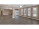 Bright living room featuring hardwood floors, plantation shutters, and an open layout leading to the outdoor space at 401 Altamira Rd, Las Vegas, NV 89145