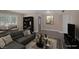 Bright living room with large windows, modern grey L-shaped couch, and stylish decor at 401 Altamira Rd, Las Vegas, NV 89145