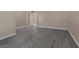 An expansive living room featuring gray wood-look floors, neutral paint, and minimalist design at 401 Altamira Rd, Las Vegas, NV 89145