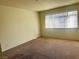 Cozy bedroom featuring plush carpet and a bright window at 4338 Caliente St # 15, Las Vegas, NV 89119