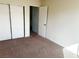 Neutral bedroom with an open door and closet at 4338 Caliente St # 15, Las Vegas, NV 89119