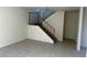 Living room featuring tile flooring and stairwell to the upper level at 4338 Caliente St # 15, Las Vegas, NV 89119