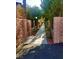 Charming walkway lined with trees and decorative brick walls, offering a tranquil path through the community at 4338 Caliente St # 15, Las Vegas, NV 89119