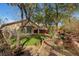 Well-maintained backyard with landscaping, trees, manicured lawn, and a charming pathway at 4593 Weitzman Pl, Las Vegas, NV 89141