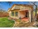 Beautiful yard with manicured lawn and covered patio featuring an outdoor ceiling fan at 4593 Weitzman Pl, Las Vegas, NV 89141