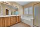 Bright bathroom features double sink vanity, soaking tub, and glass-enclosed shower at 4593 Weitzman Pl, Las Vegas, NV 89141