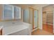 Bathroom boasts a soaking tub, separate shower, and view into a walk-in closet at 4593 Weitzman Pl, Las Vegas, NV 89141