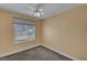 Bedroom featuring neutral walls, ceiling fan, and window for natural light at 4593 Weitzman Pl, Las Vegas, NV 89141