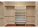 Walk-in closet with adjustable shelving and hanging rods for organization at 4593 Weitzman Pl, Las Vegas, NV 89141