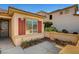 Inviting exterior with colorful red window shutters, a decorative ironwork front door and manicured landscaping at 4593 Weitzman Pl, Las Vegas, NV 89141