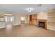 Spacious living area featuring tile floors, a cozy fireplace, and seamless access to the adjacent kitchen area at 4593 Weitzman Pl, Las Vegas, NV 89141