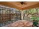 This covered patio includes tile flooring, ceiling fan, and trellis with backyard views at 4593 Weitzman Pl, Las Vegas, NV 89141