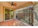 This covered patio includes tile flooring and a trellis with backyard views visible through a sliding glass door at 4593 Weitzman Pl, Las Vegas, NV 89141