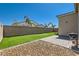 Spacious backyard with artificial turf, block wall, and a brick patio with a grill, perfect for outdoor activities at 4708 Mindful St, North Las Vegas, NV 89031