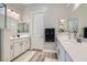 Bathroom with dual sinks, modern fixtures, and a door for privacy at 4708 Mindful St, North Las Vegas, NV 89031
