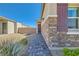 Stylish exterior featuring a stone facade, brick walkway, and desert-friendly landscaping at 4708 Mindful St, North Las Vegas, NV 89031