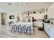 Modern kitchen with white cabinets, quartz countertops, and a large island with seating at 4708 Mindful St, North Las Vegas, NV 89031