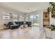 Spacious living room with stylish decor, a plush couch, and an open feel to the backyard at 4708 Mindful St, North Las Vegas, NV 89031