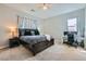 Spacious primary bedroom with a ceiling fan, neutral carpet, and a large window for natural light at 4708 Mindful St, North Las Vegas, NV 89031