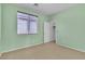 Empty bedroom featuring soft carpet, natural light from window and freshly painted green walls at 5218 Andreas Canyon Ct, Las Vegas, NV 89139