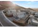 Nevada hillside home with desert landscaping, retaining walls, and views of surrounding community at 522 Riley Ridge Ct, Henderson, NV 89012