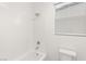 White tiled shower and bathtub with modern shower head and bath fixtures at 522 Riley Ridge Ct, Henderson, NV 89012