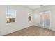 Bright bedroom with wood-look flooring, lots of natural light, and a door to the outside at 522 Riley Ridge Ct, Henderson, NV 89012